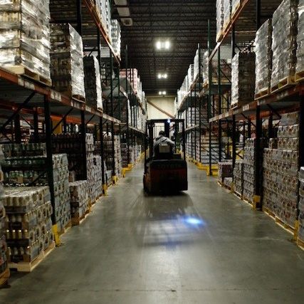 Man in warehouse driving machine